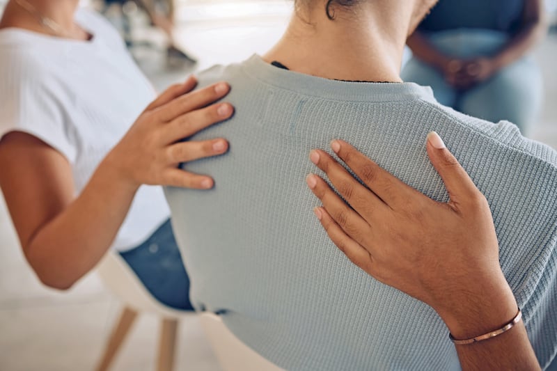 Hands, mental health and support in group therapy for woman suffering depression, stress and trauma closeup. Hand, people and aa meeting by community in trust, help and empathy for girl with anxiety